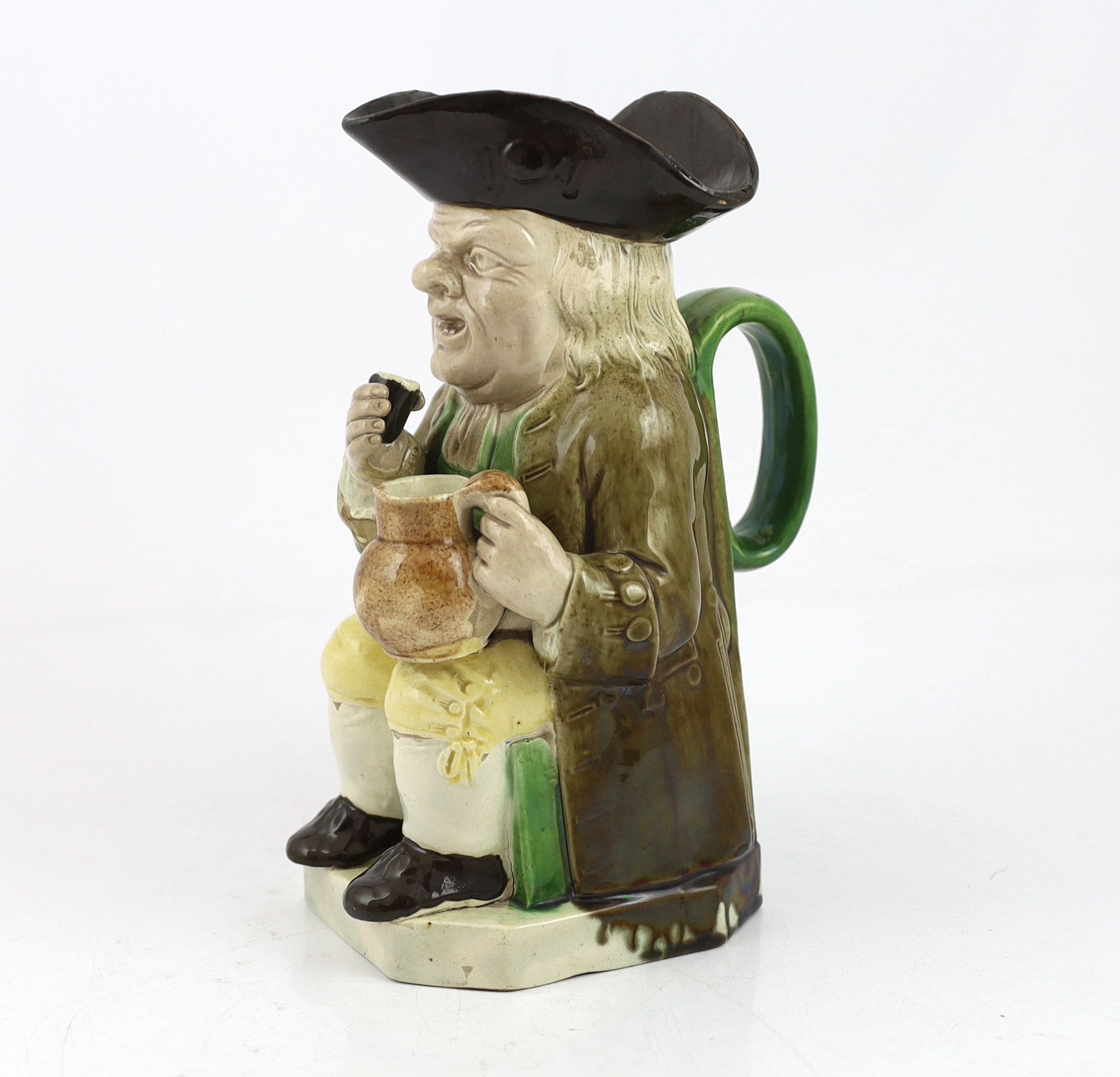 A Ralph Wood type creamware Toby jug of standard type, raising a glass to his lips, c.1790, glaze losses to rim